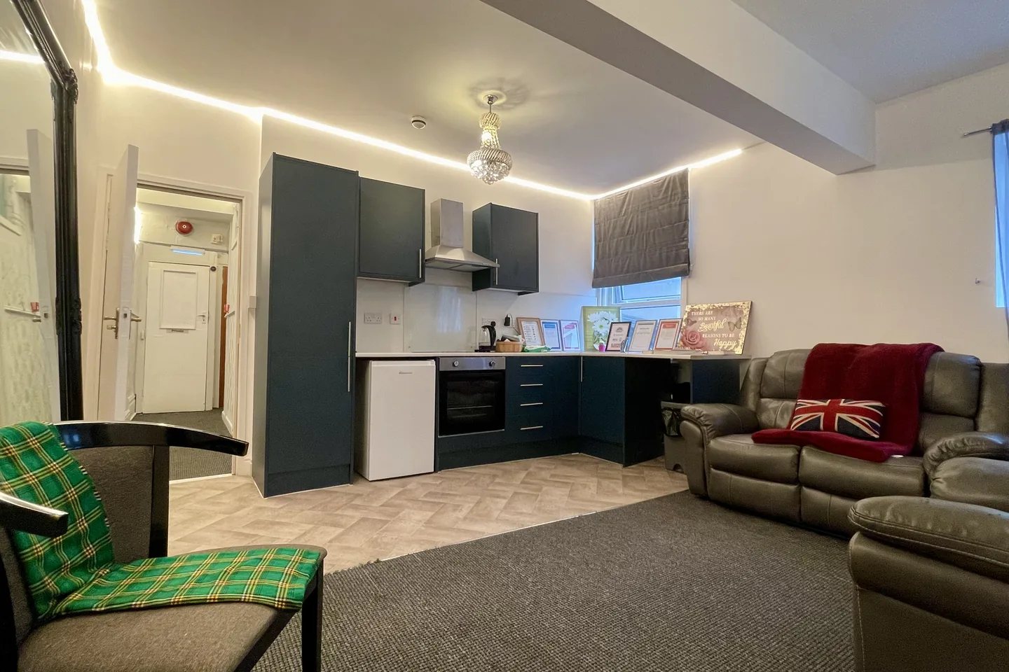 A calm, softly lit assessment room at Mwanga with comfortable seating and a small kitchen area.
