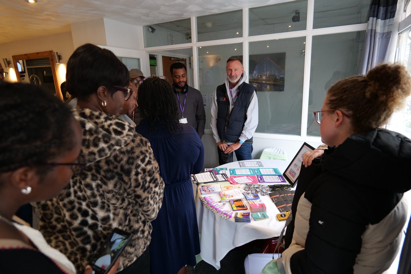 Visitors at the Mwanga launch event looking at information leaflets laid out on a table.